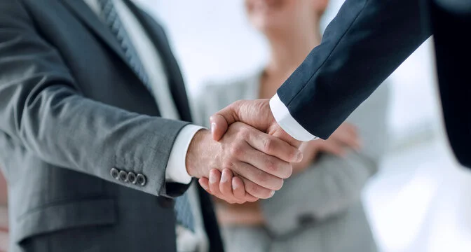 Business handshake representing end-to-end project support