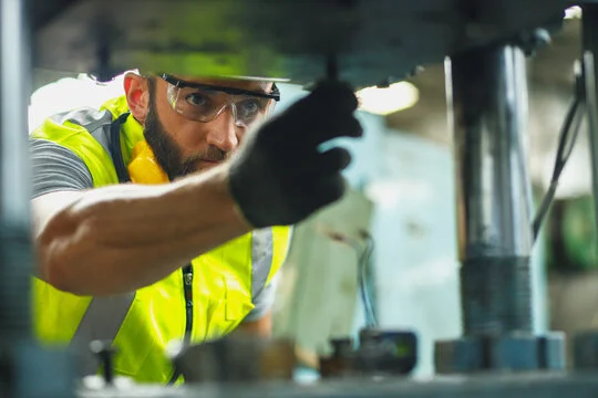 Technician performing industrial maintenance work